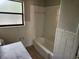 Cozy bathroom featuring tiled walls and a bathtub at 132 Terrace Dr, Winter Haven, FL 33884