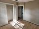 A bedroom featuring a closet with sliding doors and an open doorway at 132 Terrace Dr, Winter Haven, FL 33884