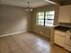 Bright dining room with tile floors, large window, and classic lighting at 132 Terrace Dr, Winter Haven, FL 33884