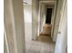Hallway with a tiled floor leading to multiple rooms in the home at 132 Terrace Dr, Winter Haven, FL 33884