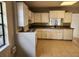 Bright kitchen featuring tiled floors, white cabinets, and modern appliances at 132 Terrace Dr, Winter Haven, FL 33884
