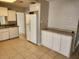 Spacious kitchen featuring modern appliances, granite countertops, and tile floors at 132 Terrace Dr, Winter Haven, FL 33884
