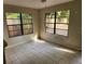 Cozy living room with tile flooring, two big windows, and natural light at 132 Terrace Dr, Winter Haven, FL 33884