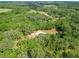 Aerial view of the home nestled among lush trees and sprawling landscape at 1406 Cr 542G, Bushnell, FL 33513