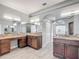 Bright bathroom featuring granite counters, dual sinks, large vanity, and a half-moon window at 1406 Cr 542G, Bushnell, FL 33513