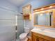 Bathroom featuring a walk-in shower with glass doors, a vanity, and overhead storage at 1406 Cr 542G, Bushnell, FL 33513