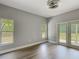 Bedroom area featuring two windows, backyard views and access to a private outdoor patio with a door at 1406 Cr 542G, Bushnell, FL 33513