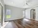 Bedroom area featuring updated flooring, a ceiling fan, natural light, and an interior closet or doorway at 1406 Cr 542G, Bushnell, FL 33513