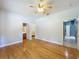 Bedroom featuring hardwood floors, a ceiling fan, and doors to a bathroom and walk-in closet at 1406 Cr 542G, Bushnell, FL 33513