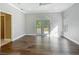 A bedroom featuring wood-look floors, neutral walls, a ceiling fan, and french doors leading to the outdoors at 1406 Cr 542G, Bushnell, FL 33513