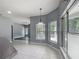 A breakfast nook featuring oversized windows, tile floors and updated pendant lighting overlooking the outdoors at 1406 Cr 542G, Bushnell, FL 33513