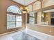 Elegant dining room with large window, chandelier, and tiled floor at 1406 Cr 542G, Bushnell, FL 33513
