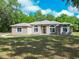 Charming one-story home boasting arched windows, a paved walkway, and lush front lawn at 1406 Cr 542G, Bushnell, FL 33513