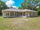 A well-maintained home with a spacious covered patio overlooking the sprawling backyard at 1406 Cr 542G, Bushnell, FL 33513