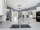 Spacious kitchen with island, gray countertops and custom cabinets, great for entertaining at 1406 Cr 542G, Bushnell, FL 33513
