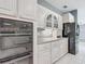 Updated kitchen featuring built-in oven, stainless steel appliances, and ample storage space at 1406 Cr 542G, Bushnell, FL 33513