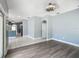 Living room area with updated lighting and flooring, flowing into the kitchen area in an open floor plan at 1406 Cr 542G, Bushnell, FL 33513