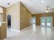 Bright and airy living room showcasing tile flooring, vaulted ceilings, and neutral paint at 1406 Cr 542G, Bushnell, FL 33513