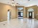 Spacious living room featuring tile flooring, ceiling fan, and view of foyer and bonus room at 1406 Cr 542G, Bushnell, FL 33513