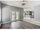 A view of an open living space which flows into a kitchen area, complete with wood-look floors and light gray walls at 1406 Cr 542G, Bushnell, FL 33513