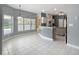 A bright living room with tile flooring, neutral gray walls, and large windows overlooking the outdoors at 1406 Cr 542G, Bushnell, FL 33513