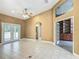 Large living room with tile flooring, vaulted ceiling and access to a private screened lanai at 1406 Cr 542G, Bushnell, FL 33513