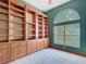 Bright home office with custom built-in bookshelves, storage cabinets, and a large window at 1406 Cr 542G, Bushnell, FL 33513