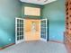 Open office room features an ornate bookshelf and double doors at 1406 Cr 542G, Bushnell, FL 33513