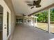Wide covered patio with ceiling fans, offering a relaxing outdoor living space at 1406 Cr 542G, Bushnell, FL 33513