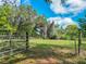 Gated yard offers privacy and enhances the beauty of the lush green space at 1406 Cr 542G, Bushnell, FL 33513