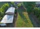 An aerial view of a spacious backyard with sheds, complemented by lush greenery and mature trees at 15714 Turkey Farm Rd, Minneola, FL 34715