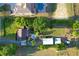 Expansive estate featuring lush landscaping, a pool, outbuildings, and ample green space on a large lot at 15714 Turkey Farm Rd, Minneola, FL 34715