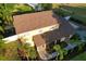 Aerial shot showcasing the home's brown roof, manicured landscaping, and inviting entryway at 15714 Turkey Farm Rd, Minneola, FL 34715