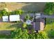 Well-manicured grounds featuring landscaping, outbuildings, and a fire pit for outdoor gatherings at 15714 Turkey Farm Rd, Minneola, FL 34715