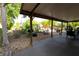 Backyard showing the shady back patio, landscaping, and comfortable seating arrangement at 15714 Turkey Farm Rd, Minneola, FL 34715