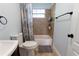 Bright bathroom featuring a tub, tile accents, neutral paint, and a window for natural lighting at 15714 Turkey Farm Rd, Minneola, FL 34715