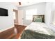 Bedroom featuring wood floors, ceiling fan, tv, and access to another room at 15714 Turkey Farm Rd, Minneola, FL 34715