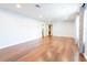 Expansive bonus room with hardwood floors, recessed lighting, and versatile space for recreation and relaxation at 15714 Turkey Farm Rd, Minneola, FL 34715