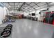Inside the oversized metal building garage, with air conditioning, work benches, and storage cabinets at 15714 Turkey Farm Rd, Minneola, FL 34715