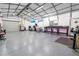 Spacious garage interior with ample room for parking and storage, featuring a workbench at 15714 Turkey Farm Rd, Minneola, FL 34715