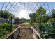 Spacious garden with metal frame, wooden garden beds, and space for growing vegetables and fruits at 15714 Turkey Farm Rd, Minneola, FL 34715