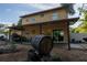 View of a covered patio with barrel fountain and a glimpse of backyard greenery and an outdoor seating area at 15714 Turkey Farm Rd, Minneola, FL 34715