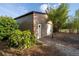 View of the large metal shed with roll up door and side entry, perfect for storage and hobbies at 15714 Turkey Farm Rd, Minneola, FL 34715
