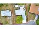 An aerial view shows the house along with other neighborhood homes and mature trees at 1805 Knox Ave, Sanford, FL 32771