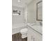 Bathroom features a tub-shower combo, a solid surface vanity, wood-look flooring, and modern fixtures at 1805 Knox Ave, Sanford, FL 32771