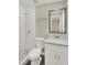 Bathroom featuring a tile shower, new toilet, mirror and a new sink at 1805 Knox Ave, Sanford, FL 32771
