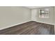 A bright bedroom with wood-look floors, a door and a window at 1805 Knox Ave, Sanford, FL 32771