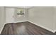 A bright bedroom with wood-look floors, a door and a window at 1805 Knox Ave, Sanford, FL 32771