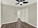 Bedroom featuring hardwood floors, a ceiling fan, closet and view to the bathroom at 1805 Knox Ave, Sanford, FL 32771
