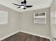 Bedroom features wood-look flooring, neutral paint, ceiling fan, base molding, and a window with blinds at 1805 Knox Ave, Sanford, FL 32771